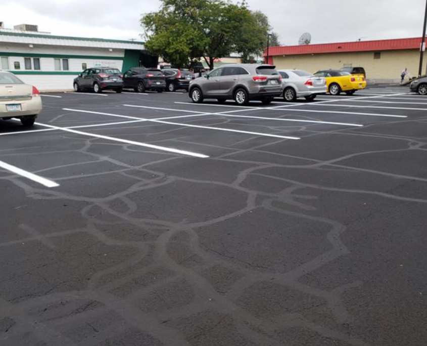 Side View Of Commercial Parking Lot Asphalt Repair