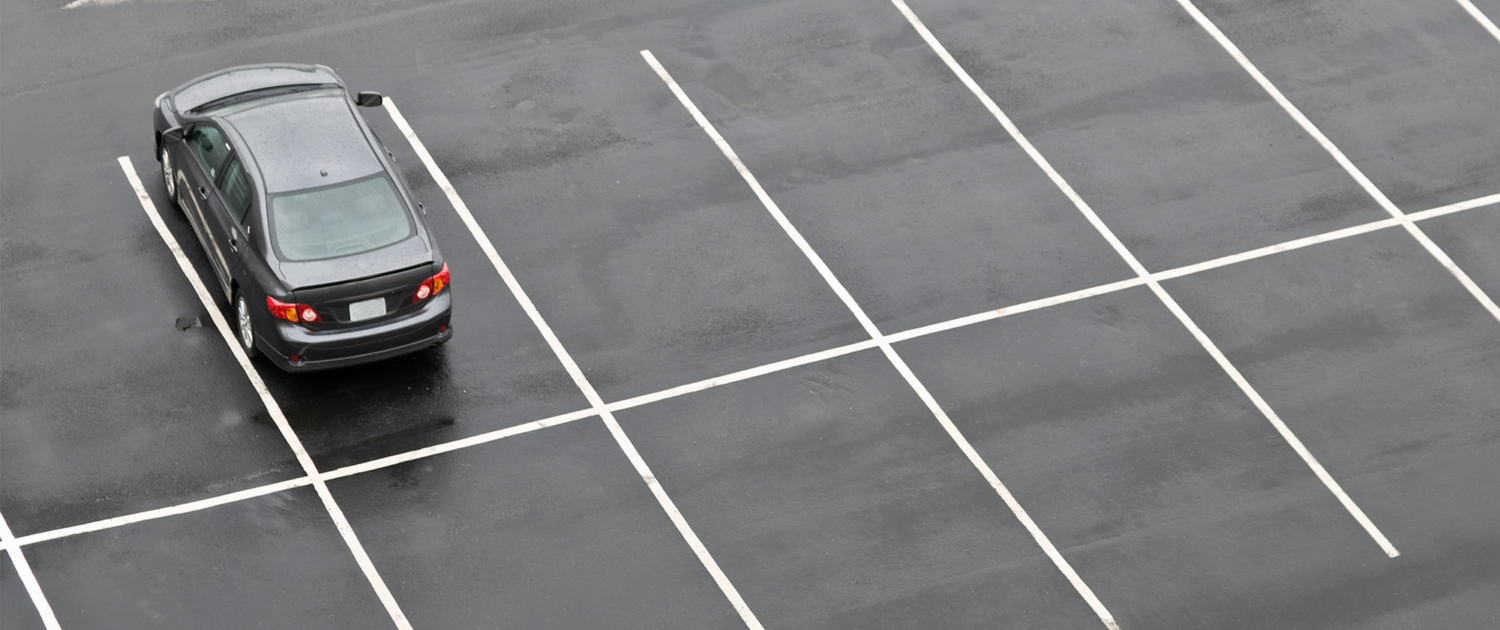Single Car In Empty Parking Lot