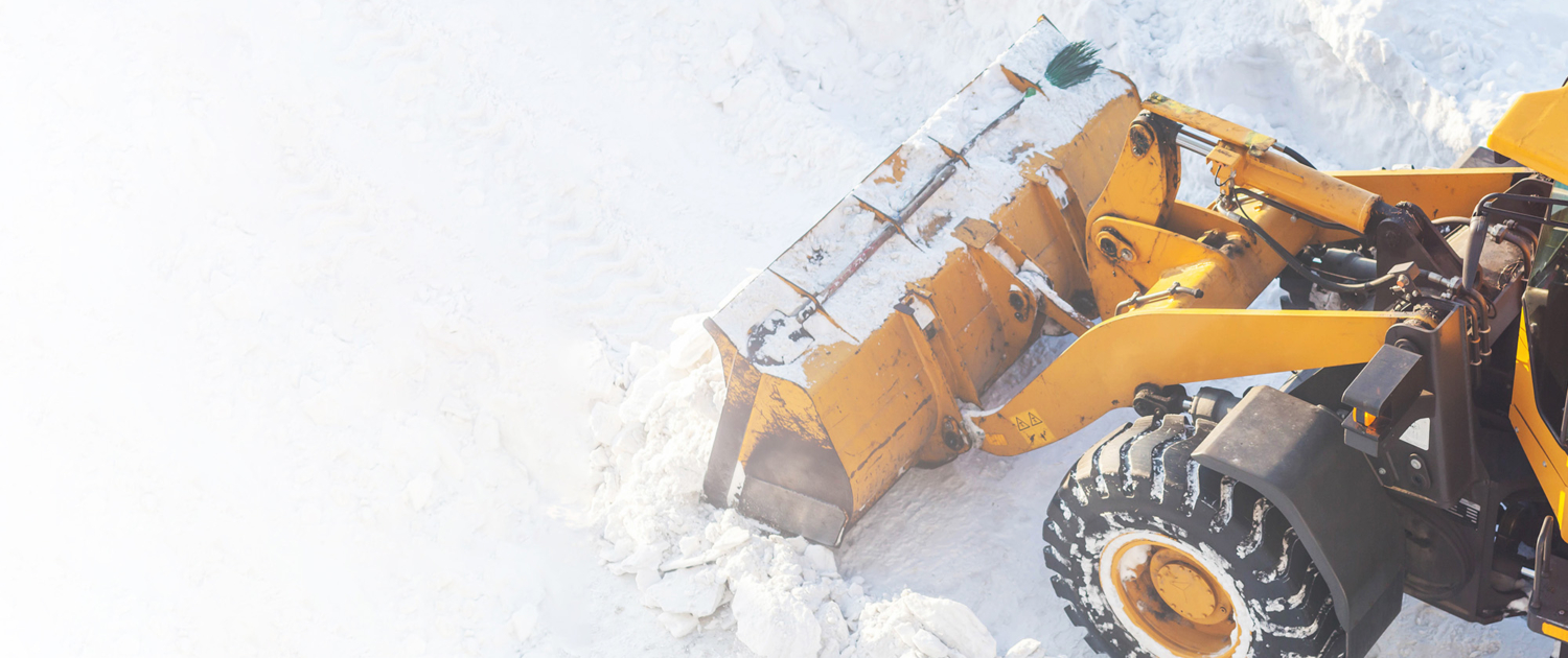 Big Orange Tractor Cleans Up Snow From The Road And Loads It Into The Truck