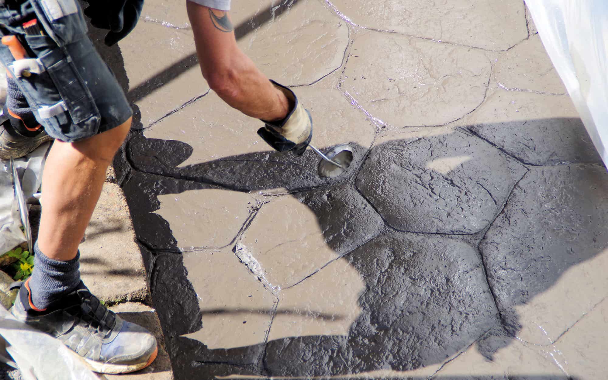 Man Making Pattern In Concrete With Tool On Terazze